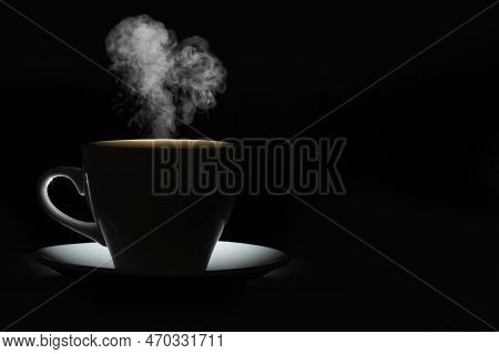 Silhouette Of A Mug With A Warm Drink And Curly Steam In The Shape Of A Heart On A Black Background.