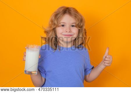 Kid Drink Fresh Milk. Funny Boy Drink A Glass Of Milk With Funny Emotions On Yellow Background. Chil
