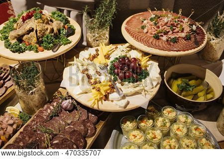 Catering Table Background. Wedding Decorative Ham Slices. Cheese Snack. Cheese Tray. Various Meat Sn