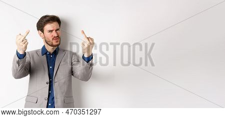 Rude Businessman In Suit Showing Middle Finger, Fuck You Gesture, Look Annoyed And Pissed-off, Stand
