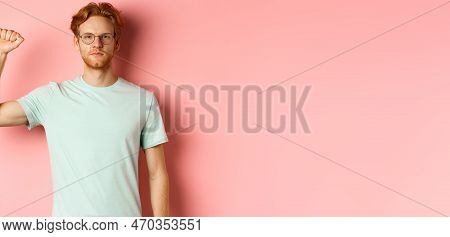 Confident Redhead Man Standing United With Black Lives Matter Movemet, Showing Raised Fist And Looki