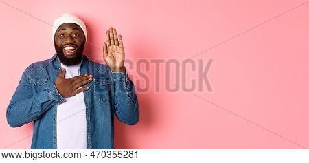 Image Of Smiling African-american Man Being Honest, Telling Truth, Hands On Heart And In Air, Making