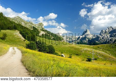 Scenic Landscape Of Mountain Valley In European Alps. Road Goes Into The Distance. Stunning View Of 
