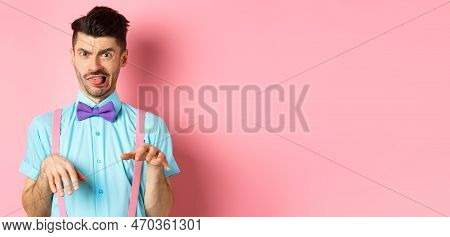 Funny Guy Looking At Something Disgusting With Aversion And Cringe, Show Tongue And Shaking Hands In