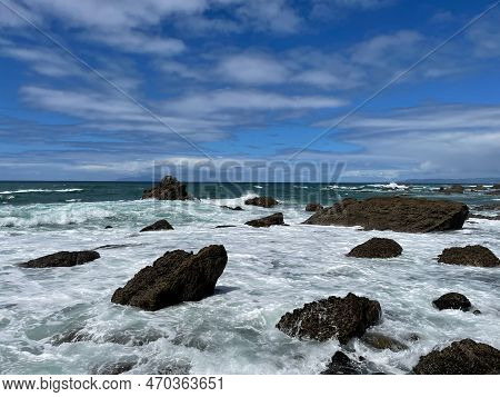 The View Of Marine Landscape. Rocks And Sea Waves In A Sunny Day. Mangawhai Cliff Walk, New Zealand.