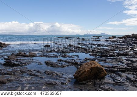 The View Of Rocky Coastline With Blue Sea And An Island On Background, Auckland, New Zealand.