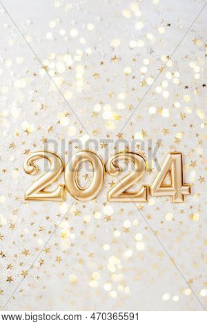 Holiday Background Happy New Year 2024. Numbers Of Year 2024 Made By Gold Candles On Bokeh Festive S