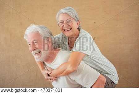 Image Of Cheerful Senior Couple Having Fun Together While Husband Piggyback His Wife, Isolated Over 