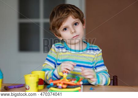 Smiling Preschool Kid Boy Having Fun With Dough, Colorful Modeling Compound Clay. Creative Leisure W