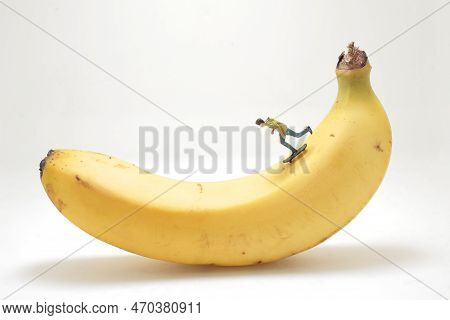 Mini Figure Of Skateboarder Jumping At Banana