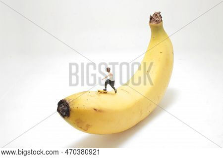 Mini Figure Of Skateboarder Jumping At Banana