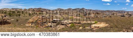 Isalo National Park In Ihorombe Region. Wilderness Landscape With Water Erosion Into Rocky Outcrops,