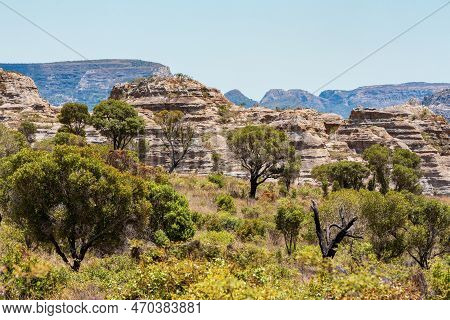 Isalo National Park In Ihorombe Region. Wilderness Landscape With Water Erosion Into Rocky Outcrops,