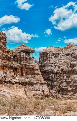 Isalo National Park In Ihorombe Region. Wilderness Landscape With Water Erosion Into Rocky Outcrops,