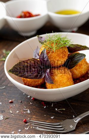 Homemade Fried Sicilian Arancini Stuffed With Meat, With Tomato Sauce