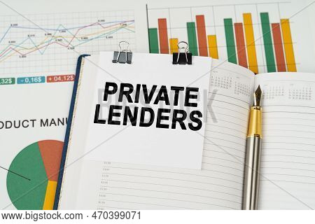Business Concept. On The Business Charts Lies A Pen, A Notepad With Note Paper With The Inscription 