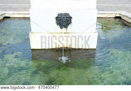 Old Palace Garden Ancient Stone Sculptured Fountain With Falling Stream Into Clean Transparent Water