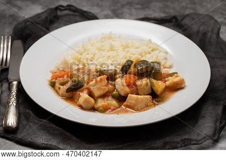Squid Stew With Vegetables And Boiled Rice On White Plate