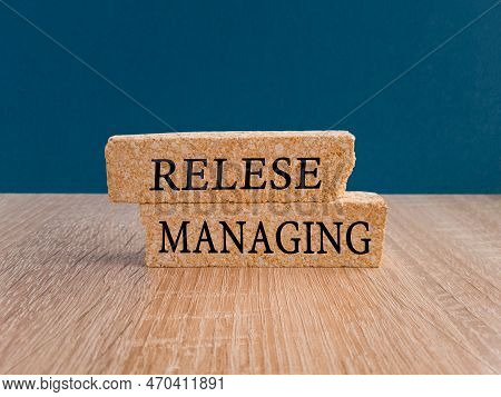 Relese Managing Symbol. Words Relese Managing Symbol On Brick  Blocks    On  A Wooden Table On A Bea