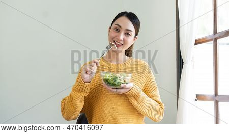 Delighted Woman Eating Food For Health At Home