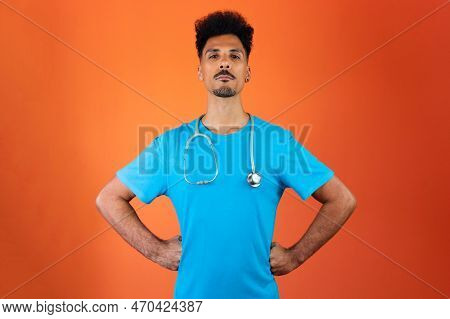 Doctor Or Veterinarian Isolated. Black Young Doctor Medical Resident With Stethoscope On Orange Back