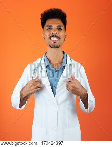 Doctor Or Veterinarian Isolated. Black Young Doctor Medical Resident With Stethoscope On Orange Back