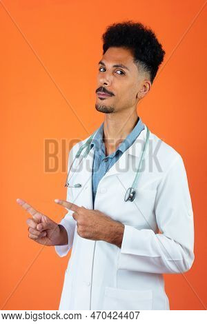 Doctor Or Veterinarian Isolated. Black Young Doctor Medical Resident With Stethoscope On Orange Back