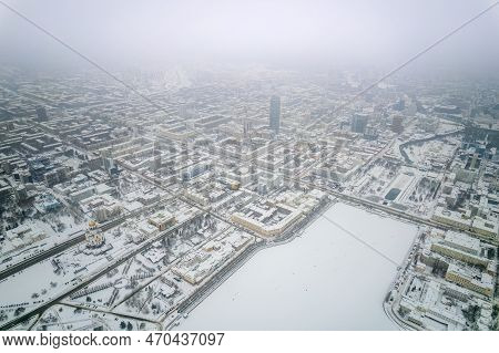Embankment Of Central Pond And Plotinka In Yekaterinburg At Winter Sunset. Winter Snow-covered City.