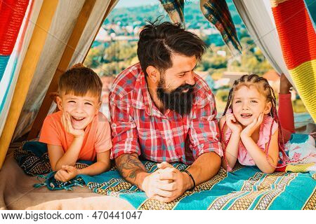 Father Have Fun With His Cute Daughter And Son. Happy Family Enjoy Being Together And Play. Young Hi