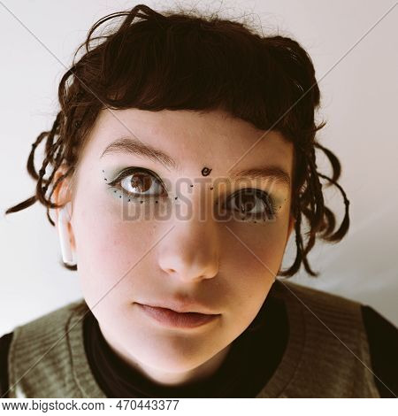 Portrait Teenage Girl With Brown Eyes, Brown Hair And Korean-style Makeup With Arrows And Dots Drawn