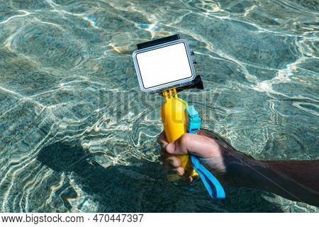 Close-up. Action Camera Mockup In The Hands Of A Guy On A Summer Day. Against The Backdrop Of Clear 