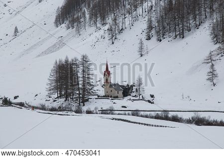 View Of Chapel Of Santo Spirito With Red Roof In The Snow In Prastmann During Winter Season