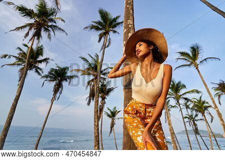 Young African Female Model Posing In Colorful Clothes At Tropical Location At Sunrise. Black Woman A
