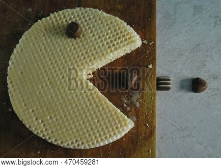 Sweet Wafer Cake With Condensed Milk In The Form Of A Pacman Trying To Eat Chocolate Candies