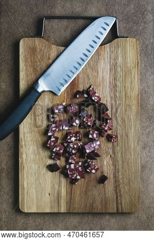 Knife And Chopped Sausage On A Wooden Chopping Board. Food Flat Lay, Top View. German Traditional Bl