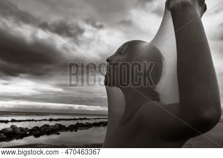 Womans Cry. Nude Woman In Transparent Fabric On The Beach.