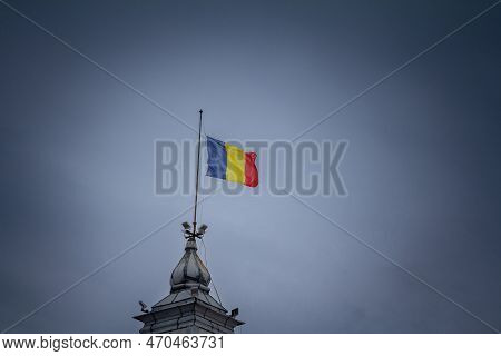 Flag Of Romania, Also Called Drapelul Romaniei Waiving On A Flagpole Of Timisoara, In Front Of A Gre