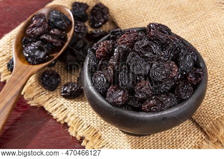 Healthy Food - Nuts Dehydrated Grapes; Photo On Wooden Background
