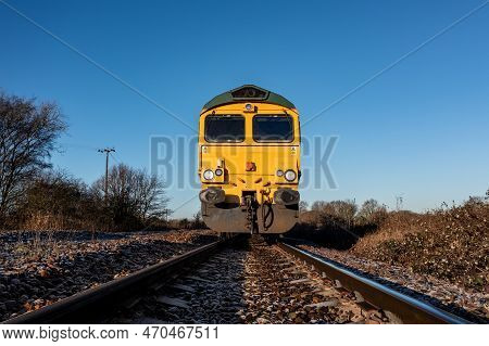 A Low Angle Front Point Of View Of A Freight Locomotive Engine Approaching A Trespasser On A Railway