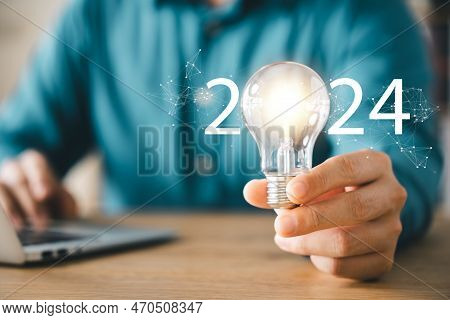 2024 Creative Concept, Business Man Holding Light Bulb 2024 Numbers, 2024 Trend Leader, Setting Goal