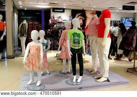Mannequins Of Men And Children In A Clothing Outlet Displaying Clothes. Interiors Of A Clothing Outl