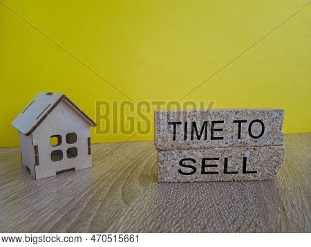 Time To Sell House Symbol. Concept Words 'time To Sell' On Wooden Blocks Near Miniature Houses. Beau