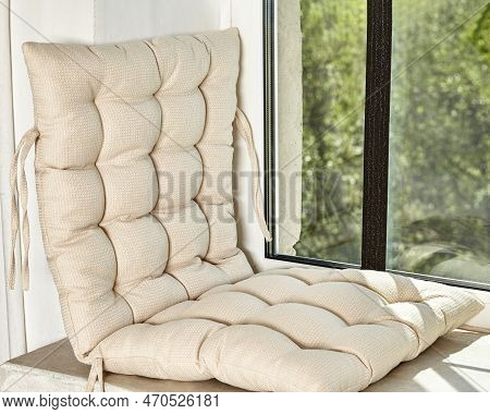 Cozy Resting Area On Windowsill With Beige Fabric Cushion
