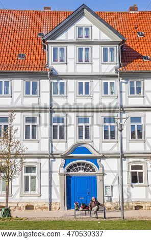 Wolfenbuttel, Germany - March 23, 2022: 
Man On A Bench On The Historic Holzmarkt Square In Wolfenbu
