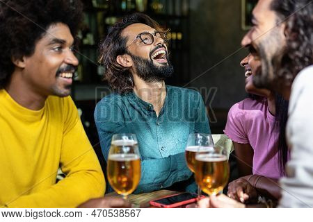Young Group Of Happy People Drinking Cold Beer At Brewery Pub. Multiracial Colleagues Enjoying Happy
