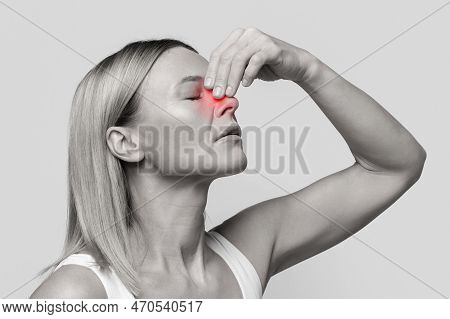 Middle Aged Woman Suffering From Nasal Bleeding, Closeup