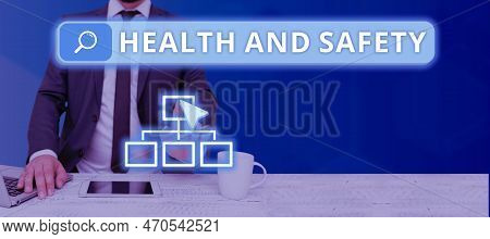 Hand Writing Sign Health And Safety. Word For Taking The Appropriate Steps To Protect Yourself From 