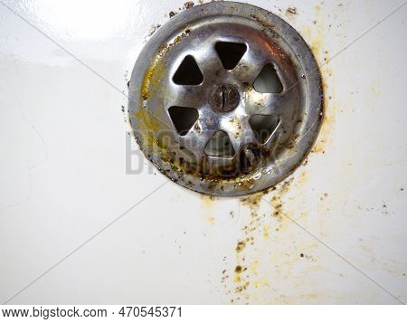 Bathroom Drain Dirty. Siphon Element. Plumbing. Mold On Bathroom Enamel. Black Dots Of Mold And Yell