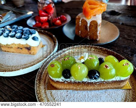 Several Kinds Of Fruit Cake On The Table, Focused On Shine Muscat Grape Cake.