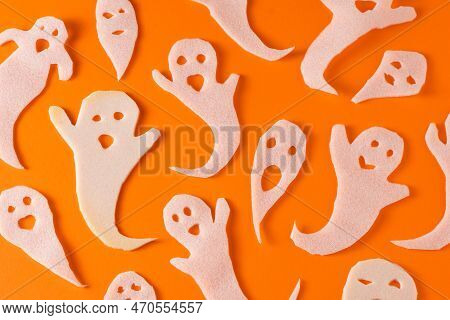 White Ghosts Kids Craft For Halloween. Wrapping Paper Ghost On Orange Background Top View. A Scary A